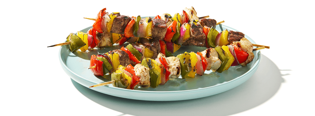 Chicken & beef kabobs on a turquoise plate
