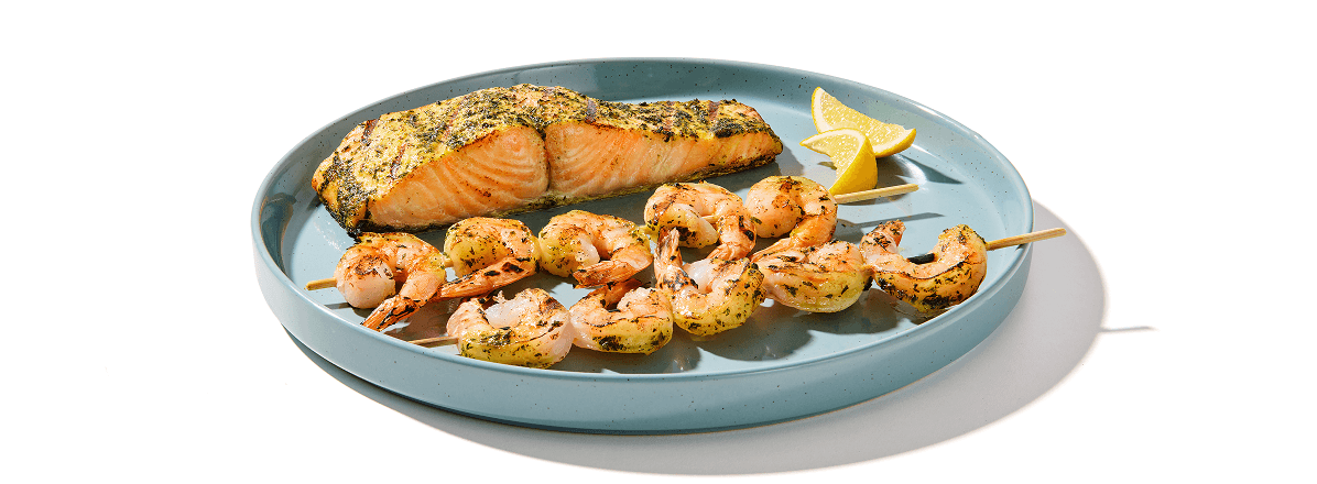 Plate of shrimp kabobs and salmon filet
